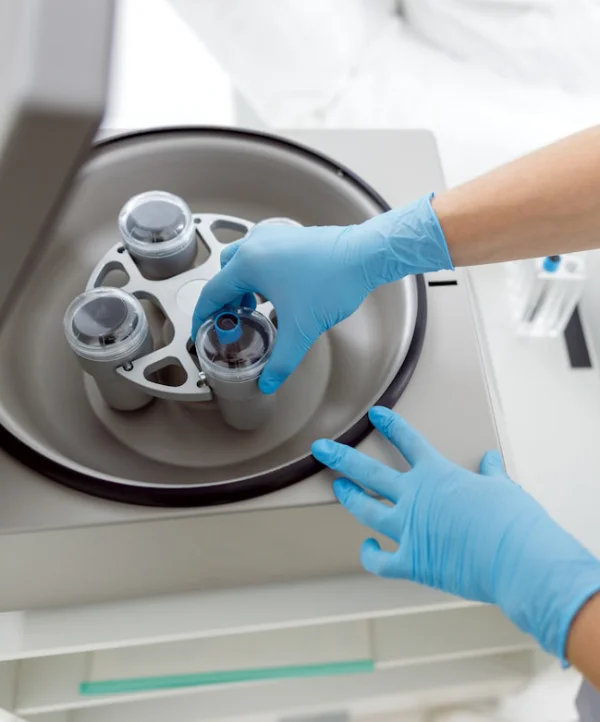 The Power of PRP A practitioner placing extracted blood into a centrifuge